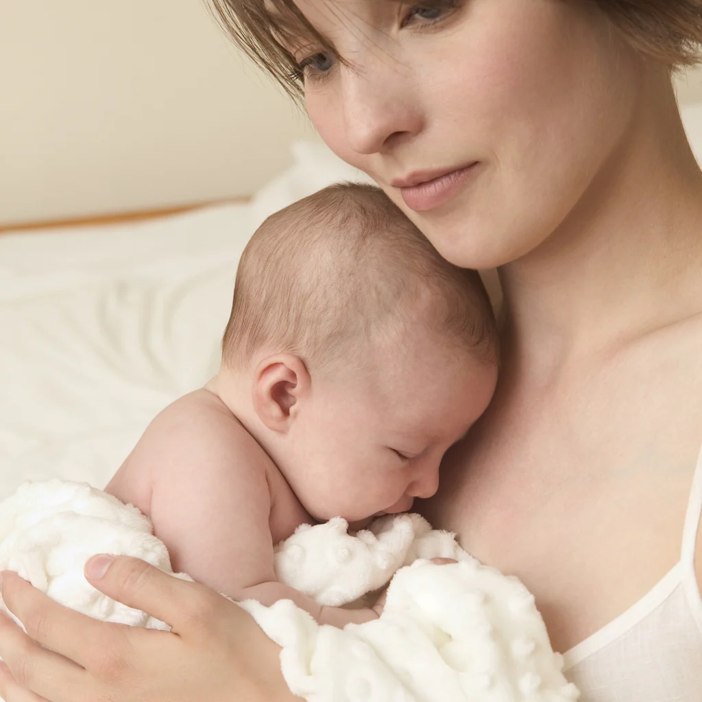 Postpartum hair loss — mother with newborn baby