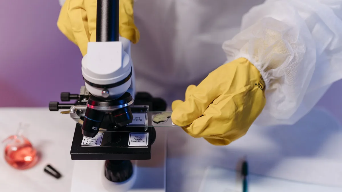 Close-up of a microscope with a glass slide, as used to examine a scalp biopsy sample for hair loss diagnosis